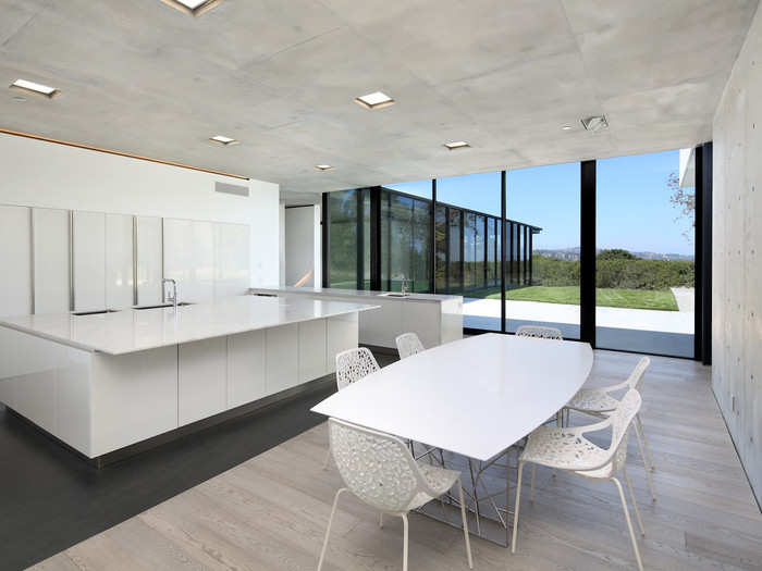 Downstairs is a spotless kitchen that includes seating at the island counter, which is carved from Italian Carrara marble.