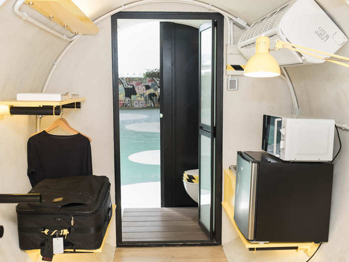 The O-Pod includes a sofa that folds out into a bed, as well as shelves, a mini-fridge, a microwave, and an air conditioner.