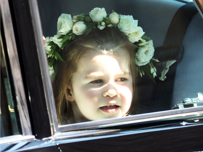 Princess Charlotte was eager to arrive as she pressed her face towards the car window.