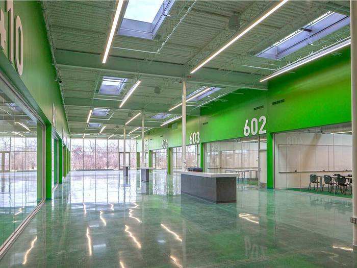 The team installed windows, skylights, and floor-to-ceiling glass curtain walls that look out to a wetland. Natural light now floods the space.