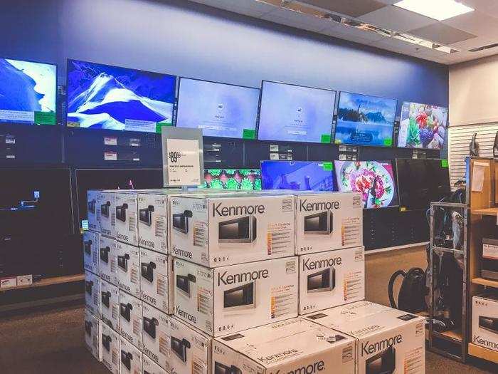 Microwaves and other appliances were in the middle of the floor, spilling over from the neighboring appliances display.