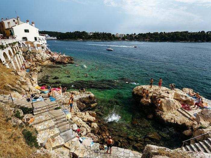 Have an idle afternoon sunbathing on rocks or watching fishermen untangle their nets in Rovinj, Croatia.