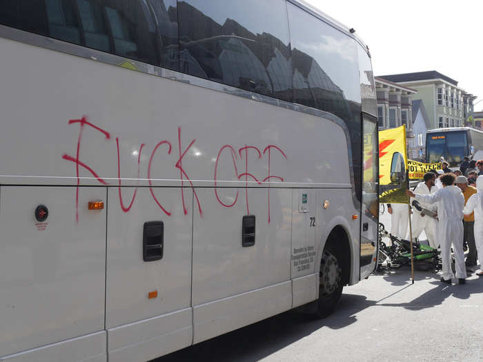 Someone spray painted some choice words on one of the buses as employees sat inside.