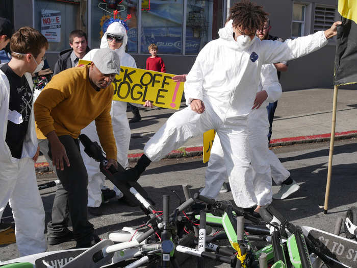 Just after the protest started, a man got out of one of the buses and started to remove scooters to clear the street. "It