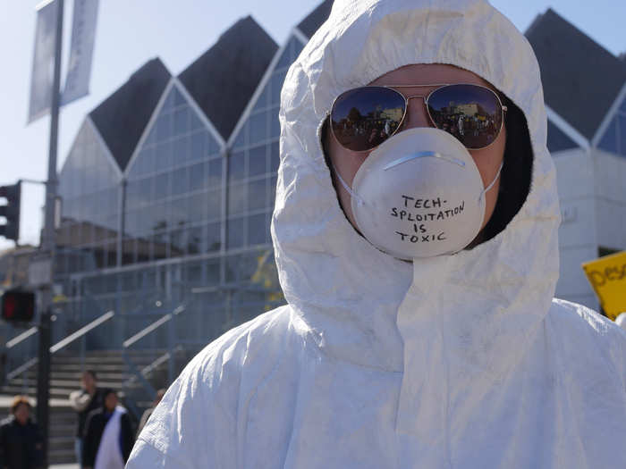 To make their point that Big Tech is "toxic," protesters dressed in white hazmat suits and masks.