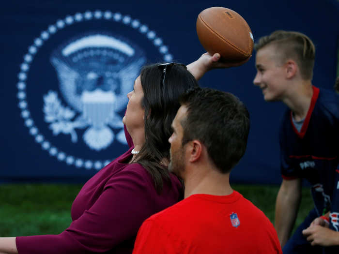 Sanders went straight from her afternoon press briefing to the event in time to pass a football.