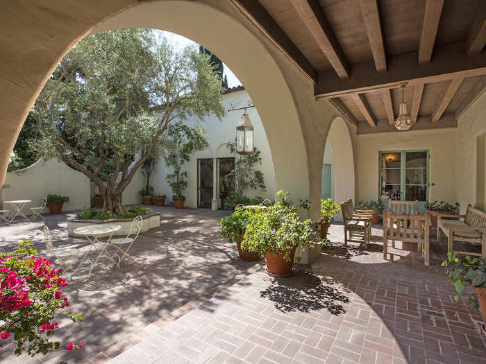 Head outside to the large court with a fountain, trees…