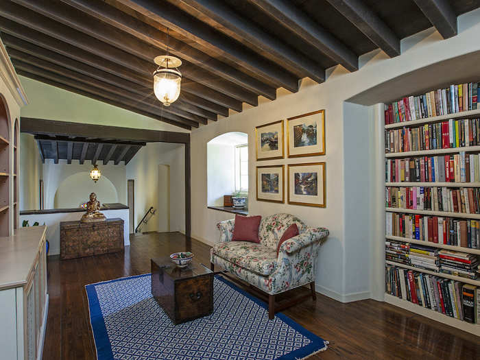 The mansion even boasts a library with a corner fireplace and carved wood ceiling.