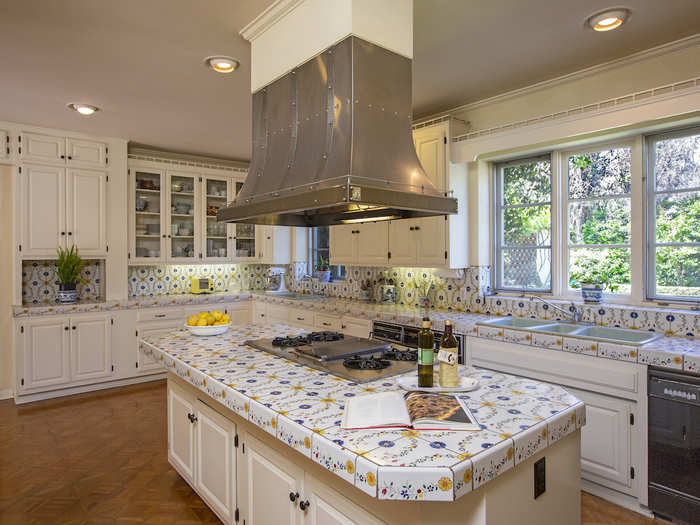 The kitchen has hand-painted countertops and an island, and there