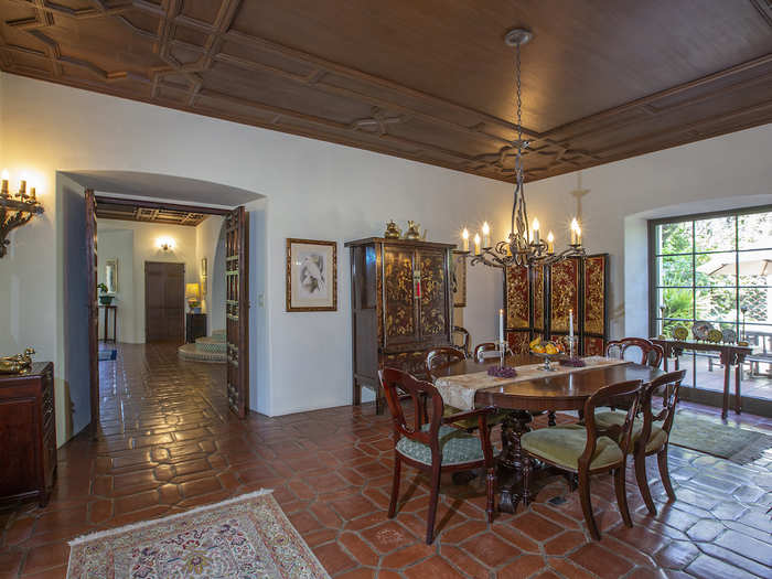 The formal dining room can be reached through carved wood double doors.