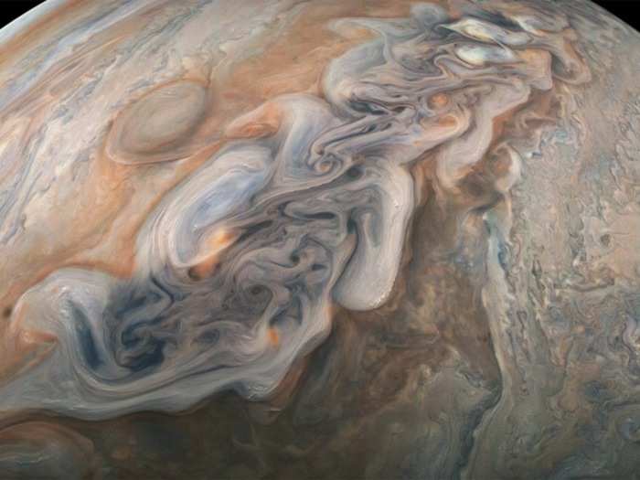 Some storm clouds pile into bands that circle much of Jupiter — a planet more than 300 times as massive and more than 1,300 times as voluminous as Earth.