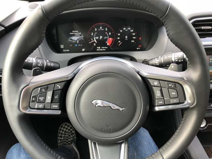 The driver is presented with a leather-wrapped steering wheel, outfitted with the usual bevy of buttons to control vehicle functions; and a digital-analog instrument cluster.