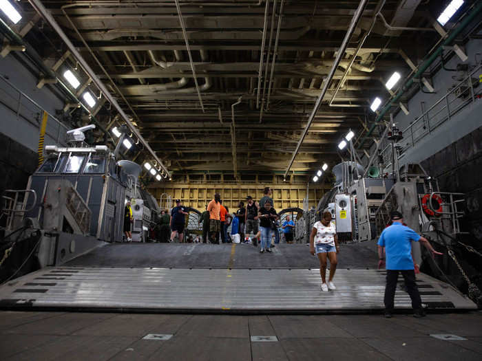 This is a landing craft air cushion, which brings vehicles and marines ashore. The Arlington can hold two LCACs in the well bay, or one landing craft utility ship.