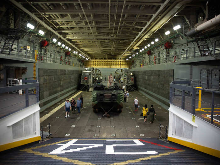 Upon entering, the well deck is to the left, which is where the ship transports marines and vehicles, such as the amphibious assault vehicle in the middle, ashore.