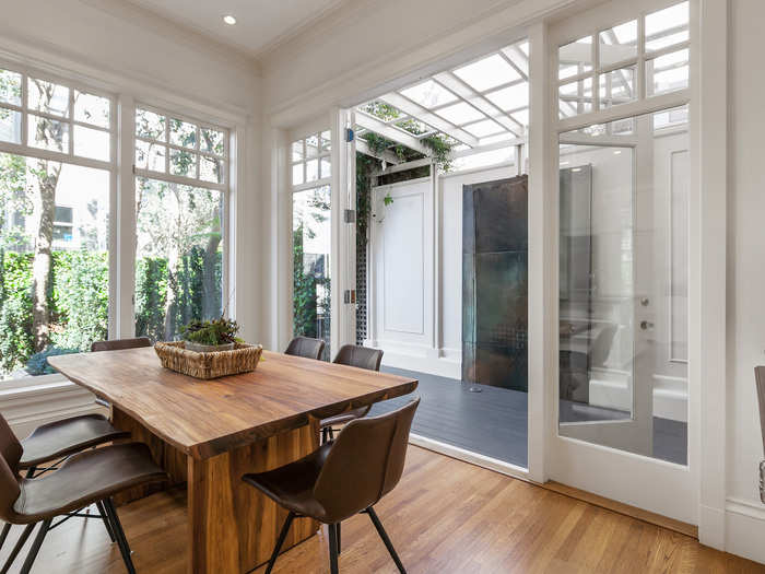 A pair of doors leads to a deck off of the main level, where guests and occupants can meander into an enclosed garden area.