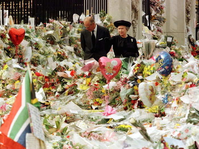 1997: Philip and his wife, Queen Elizabeth II, walk through a sea of flowers left by the public outside Buckingham Palace in memory of Princess Diana, who was killed in a car crash in Paris in August that year.