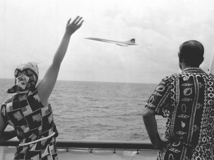 1977: This photo captures Prince Philip and Queen Elizabeth waving at a low-flying Concorde as it passed the Royal Yacht Britannia near Barbados. The iconic passenger jet could fly faster than the speed of sound but made its last flight in 2003 due to soaring costs.