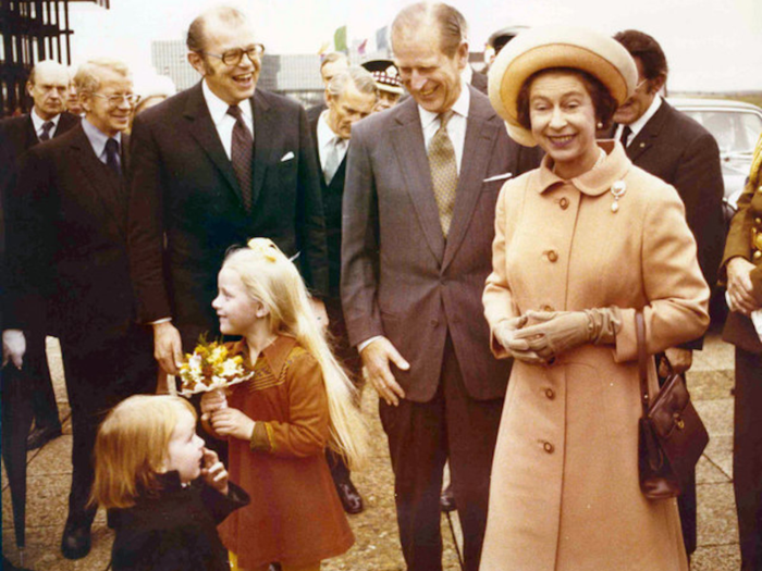 1976: The royal couple laughed as the young girl stood next to them was reluctant to hand over a bouquet of flowers during their royal visit to Luxembourg.