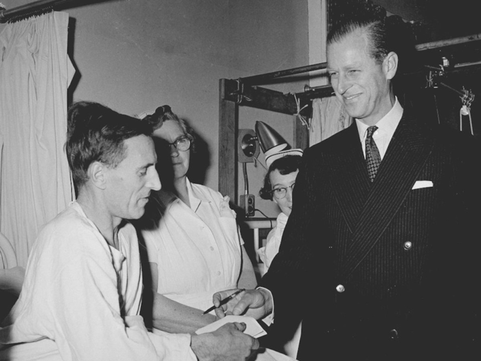 1958: Here, Prince Philip is handing a pen back to Levi Milley after signing an autograph. Milley was one of 12 men who survived nearly a week trapped in a mine in SpringHill, Nova Scotia in 1958.