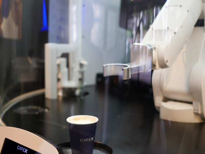 The robotic arm pivots and goes about its business to brew your coffee once an order is placed.