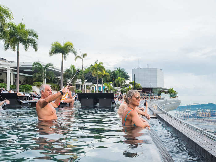 Just about everyone in the pool is doing one thing: swimming to the edge and taking photos of the skyline over the infinity pool. There was exactly one person swimming laps, and he was pissing everyone off.