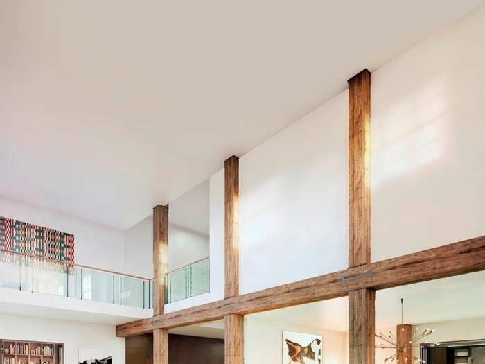 Double-height ceilings create a bright and airy living space. Some original features of the building remain intact, such as the Carolina yellow pine beams, which are each more than 150 years old.