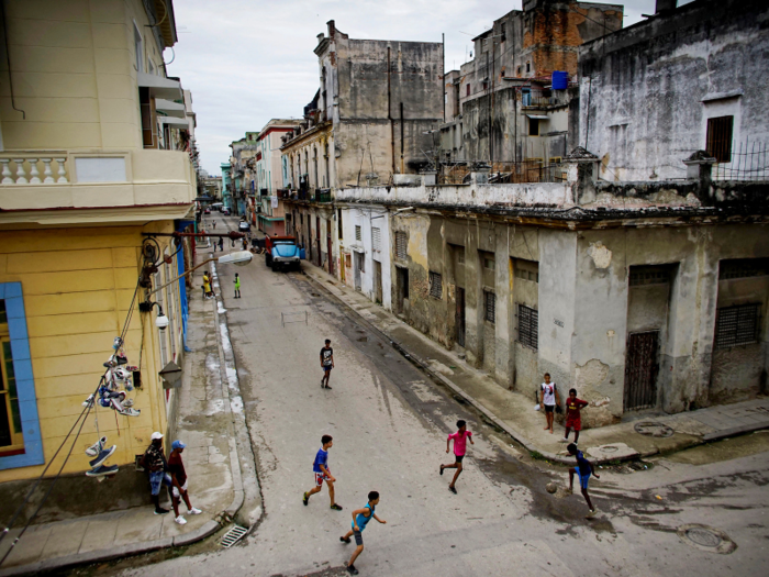 No playing space is too narrow for a game, as these children on the streets of downtown Havana, Cuba, demonstrate.