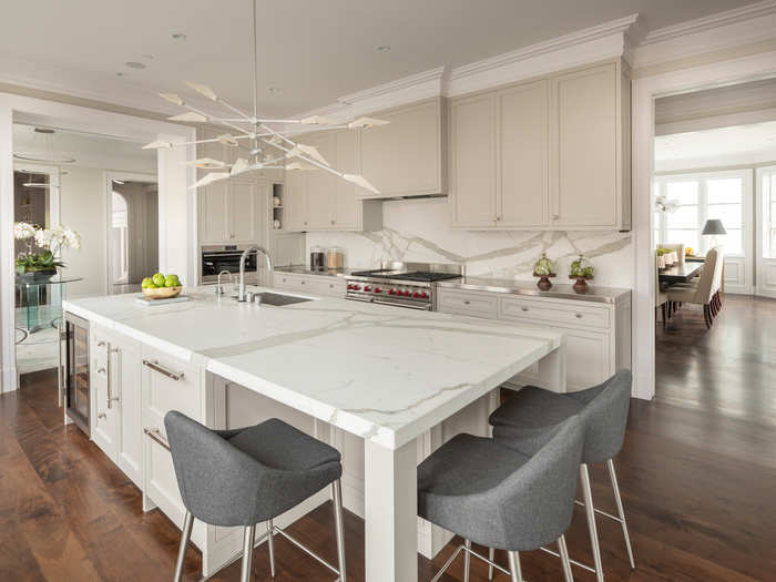 An island in the kitchen allows for a seating area.