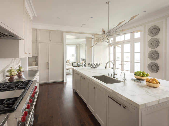 The kitchen is no different, with marble counters and white finishes all around.