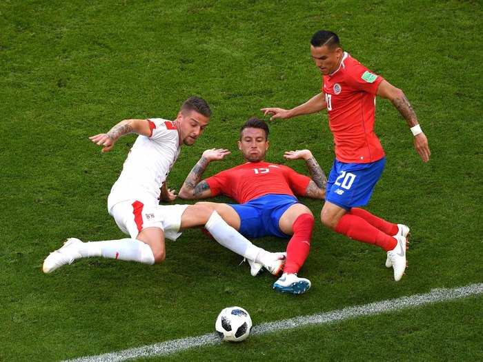 Serbian and Costa Rican players battle for the ball.