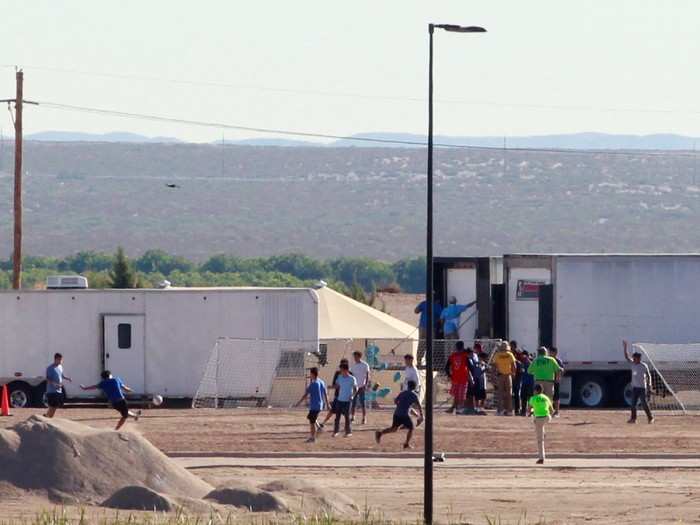 Children play soccer at the newly created encampment.