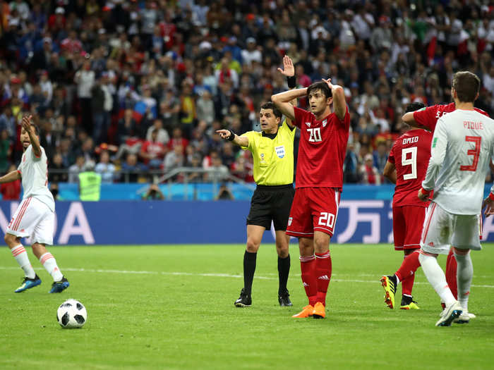 Sardar Azmoun of Iran looks on in disbelief as the referee disallows a goal that would have tied the match after video review.