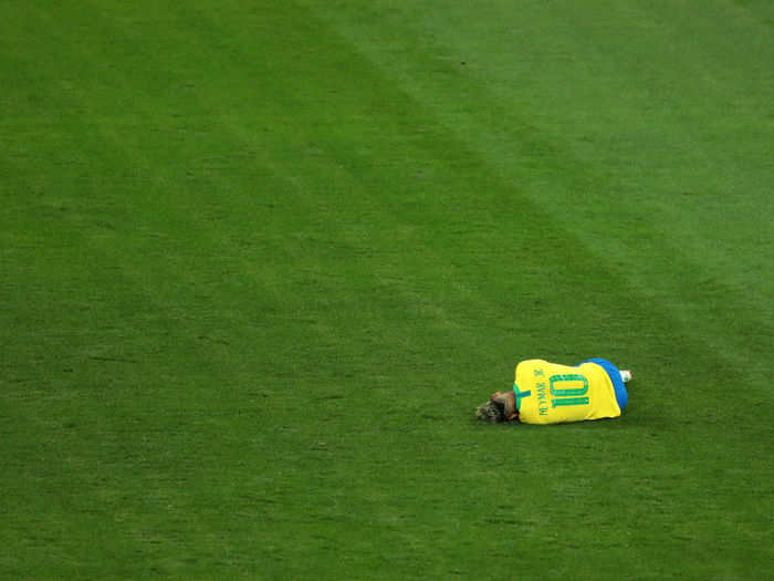 Neymar lies on the ground after getting fouled yet again in Brazil
