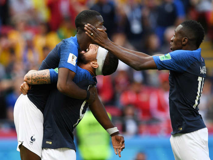 Olivier Giroud lifts teammate Paul Pogba up in the air after the latter scored the go-ahead to give France a 2-1 victory over Australia.