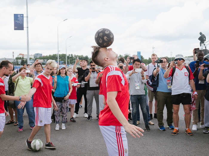 A few Polish footballers were showing off their skills with the soccer balls. One of them started doing wild capoeira flips immediately after.