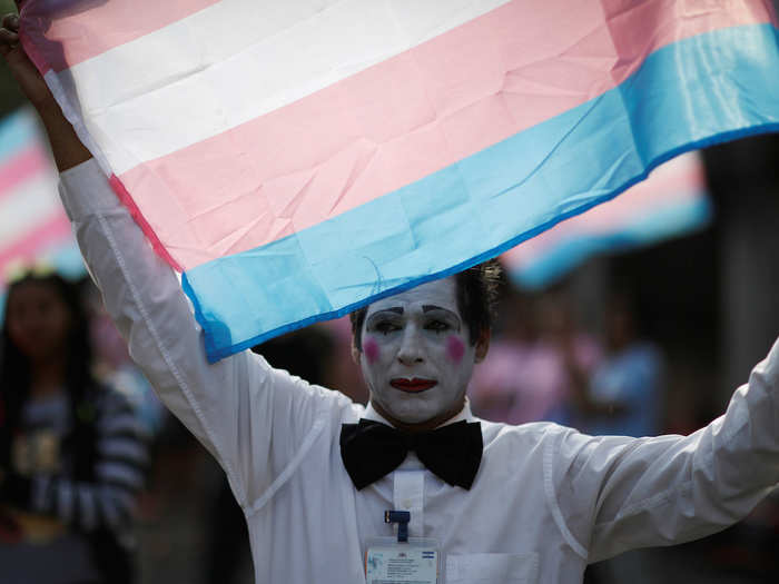 People held up transgender pride flags at El Salvador