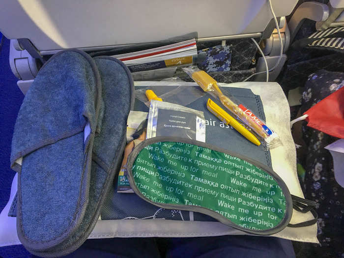 The package included slippers, ear plugs, a dental kit, pen, hand cream, and an eye mask. The mask had two sides: a red side that said “Do Not Disturb” and a green side that said "Wake Me Up For Meal." Very clever.