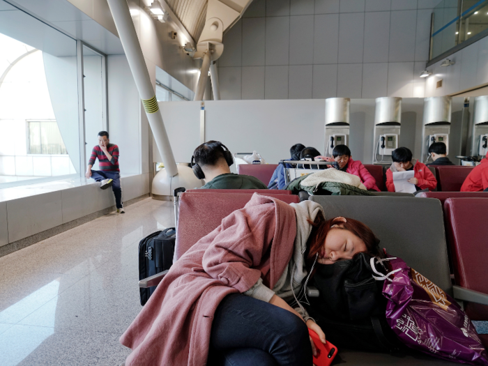 She took a quick nap at the Beijing airport with bags of traditional food and gifts for Quanming