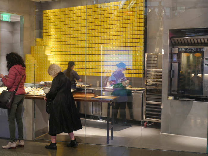 ...only to find that there was no line whatsoever. The entire ordering process from start to finish took maybe three minutes. The shop included of a wall of bright yello boxes for packaging the tarts, and an oven.