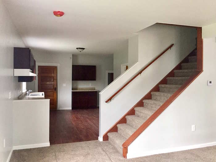 Inside, SVR built a custom handrail for the stairs, knocked down a wall to open up the floor plan, and gave the home a new kitchen.