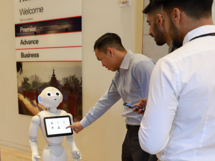 Pepper communicates by speaking, either directing customers to a human banker or answering simple questions with options shown on a screen.