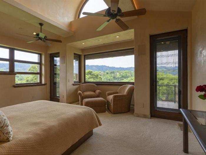 The master bedroom also includes a skylight as well as windows with the hillside in plain view.