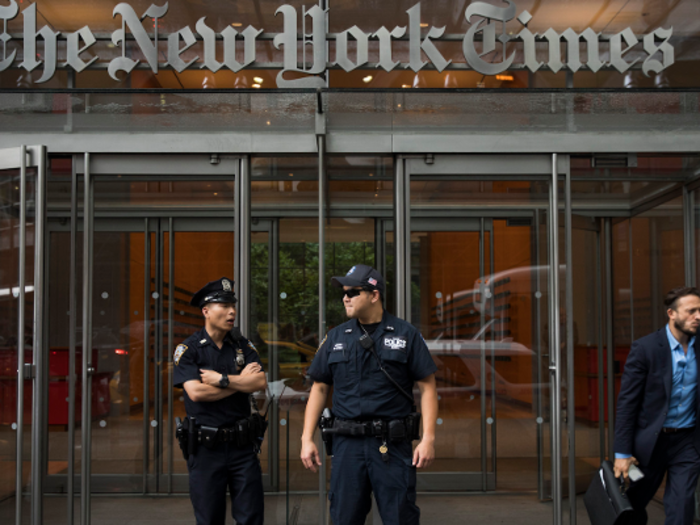 New York City Police Department officers stand outside the headquarters of The New York Times, June 28, 2018 in New York City.