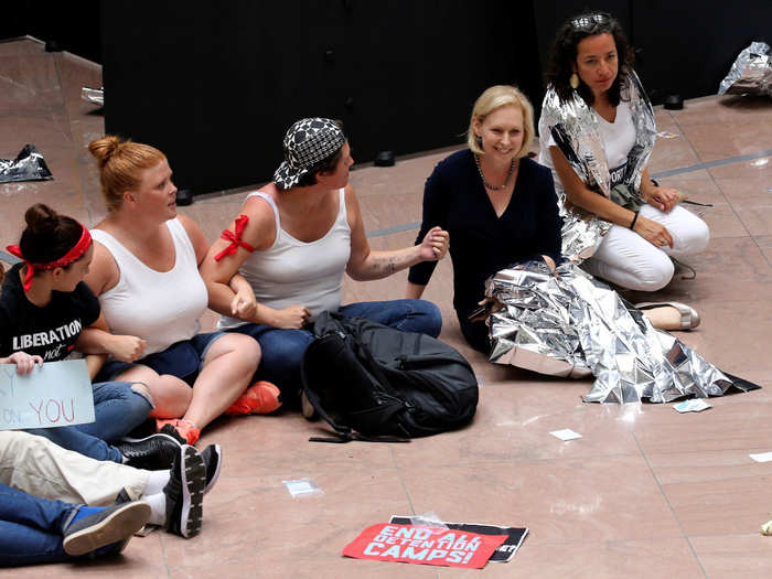 Sen. Kirsten Gillibrand of New York made herself comfortable on the floor, wrapping herself in a foil blanket.