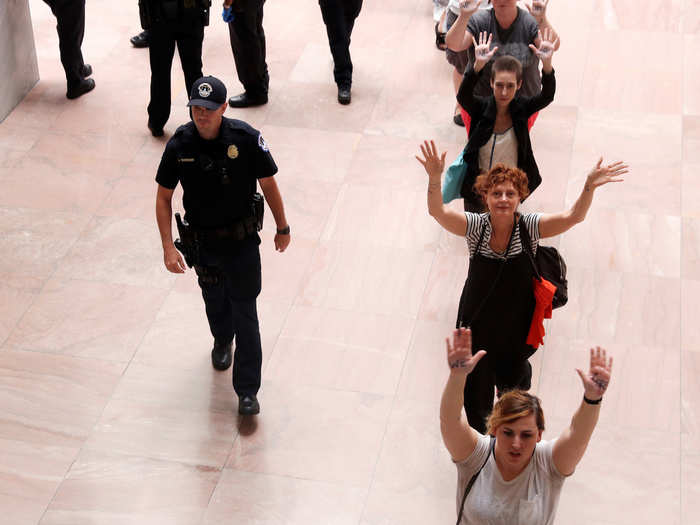 Actress Susan Sarandon joined in a line of protesters as Capitol Police led them out of the atrium to be arrested.