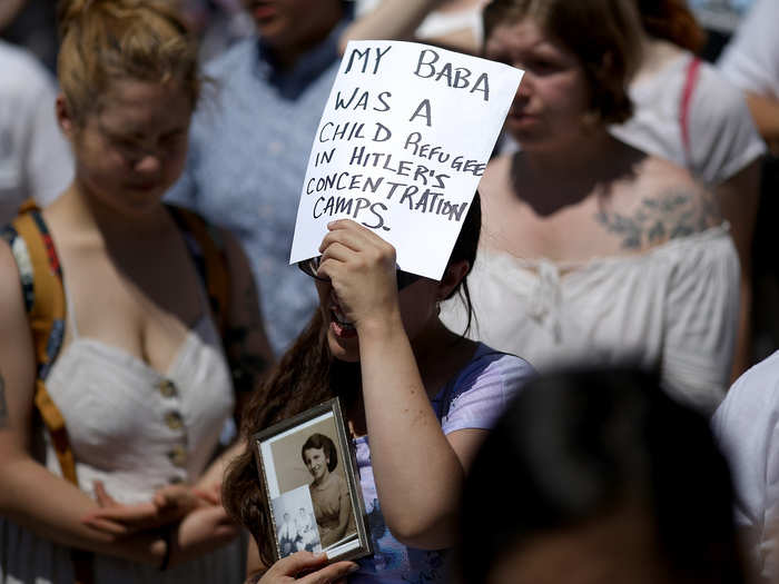 One woman held up a powerful photo and sign of her grandmother, a Holocaust survivor. Many have compared the family separation to various forms of concentration camps throughout history