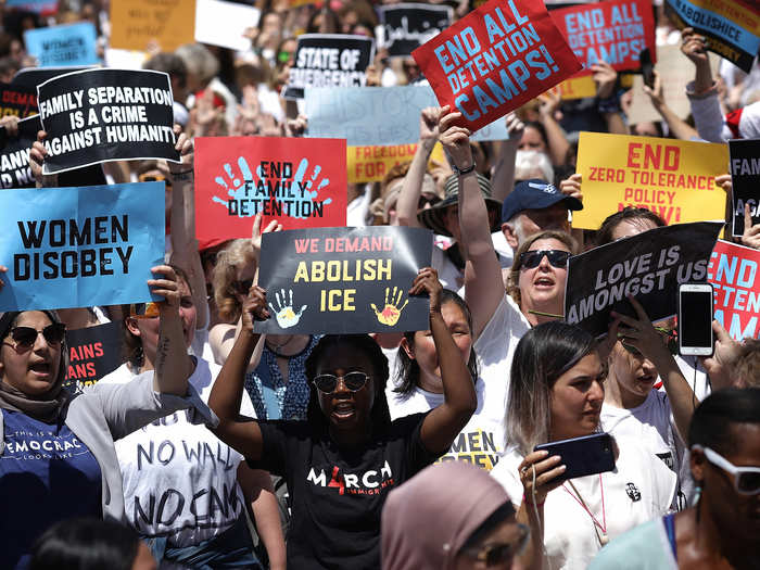 Protesters held colorful signs calling for an end to family separations, reunification of families, and the dissolution of ICE