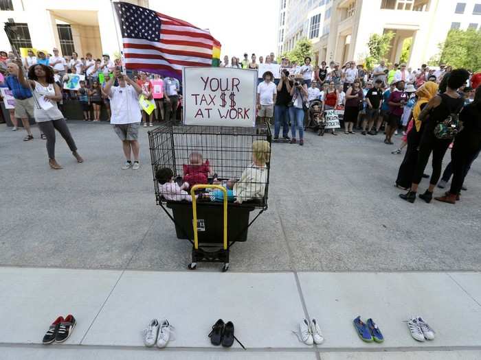 Thousands gathered in front of the statehouse in Indianapolis, Indiana, where a model cage and children