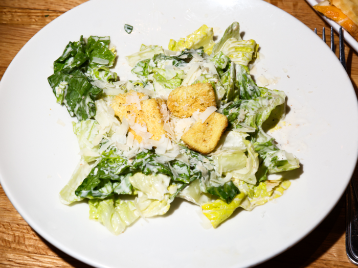 The deal also includes either an appetizer or a side salad. Since we went all in on the app combo, we got the Caesar salad — a dressing-drenched classic.