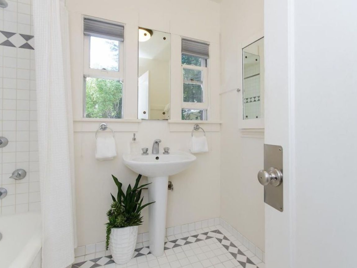 The one bathroom in the house is decked out in modern tiled floor and clean, white finishes.